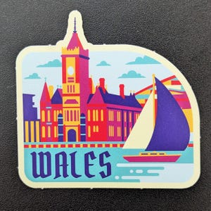 May include: A colorful sticker featuring a Welsh landmark with a clock tower, red and purple buildings, and a sailboat on blue water. The word "WALES" is printed in a stylized font.