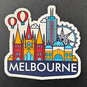 May include: A vibrant sticker depicting Melbourne's skyline, with a Ferris wheel, high-rise buildings, and hot air balloons. The word "MELBOURNE" is written in white on a navy blue banner.