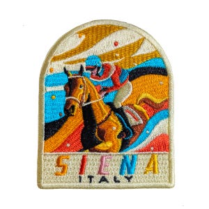 May include: Embroidered patch featuring a horse race scene with a jockey in red and blue riding a brown horse. The patch has the text "SIENA ITALY" in colorful letters, set against a cream-colored background with a curved top.