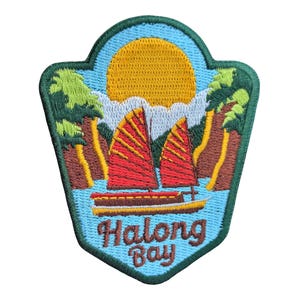 May include: Embroidered patch depicting Halong Bay. The design shows a yellow sun, red-sailed boats, and the text "Halong Bay" in a decorative font, set against a blue and green backdrop. The patch has a green border.