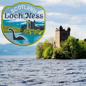 May include: Embroidered patch featuring the text "Scotland Loch Ness" with an image of the Loch Ness Monster and a castle. The patch has a blue, green, and yellow color scheme. The background shows a castle on a small island.