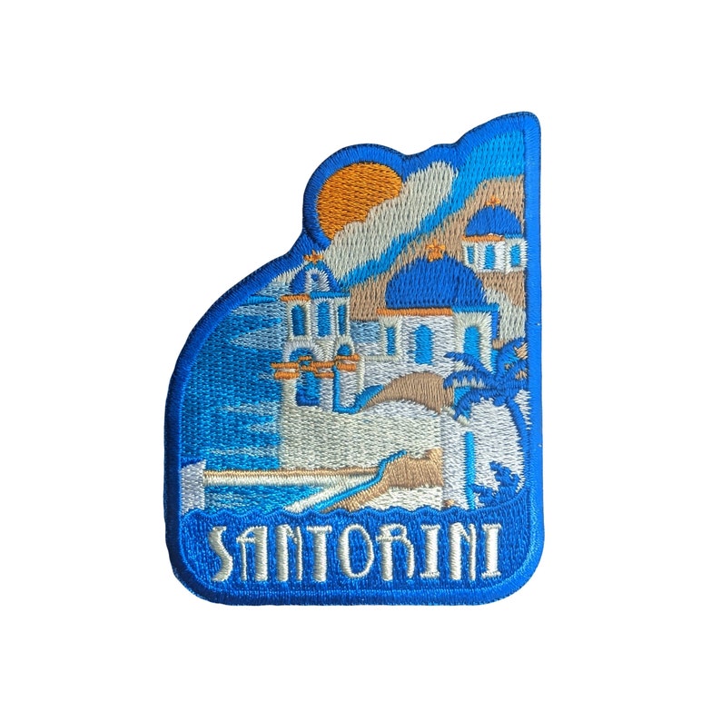 May include: Blue and white embroidered patch with a depiction of a white building with blue accents and a palm tree. The text "Santorini" is embroidered in white on a blue background.