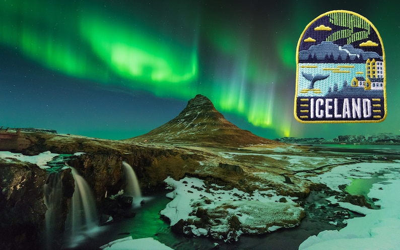 May include: An embroidered patch featuring an Iceland landscape with a whale, mountains, and buildings, set against a backdrop of the Northern Lights. The word "ICELAND" is displayed in white text.