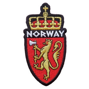 May include: Embroidered patch featuring the Norwegian coat of arms. The design includes a gold lion holding an axe on a red shield, with the word "NORWAY" above. The patch is outlined in black and has a gold crown.