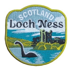 May include: Embroidered patch with the text "Scotland Loch Ness". The design shows the Loch Ness Monster in a teal lake, a castle, and a light blue sky. The patch has a yellow border. Ideal for jackets or bags.