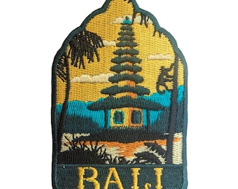May include: Embroidered patch featuring a Balinese temple scene with a yellow sky, blue water, and palm trees. The patch has a dark teal border and the word "BALI" in yellow.