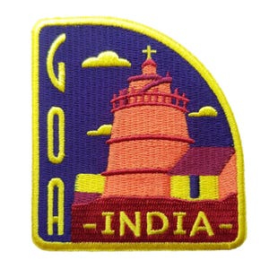 May include: Embroidered patch featuring a lighthouse with a cross on top, set against a purple background with yellow clouds. The patch reads "GOA - INDIA" in yellow and red lettering, framed by a yellow border.