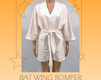 May include: A white batwing romper with a tie waist. The romper is made of a lightweight fabric and has a relaxed fit. The text "BAT WING ROMPER" and "PDF SEWING PATTERN | LETTER SIZE" is printed below the image.