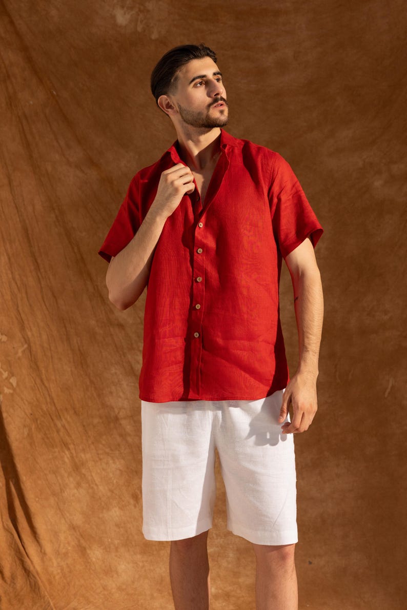 a man in a red shirt and white shorts
