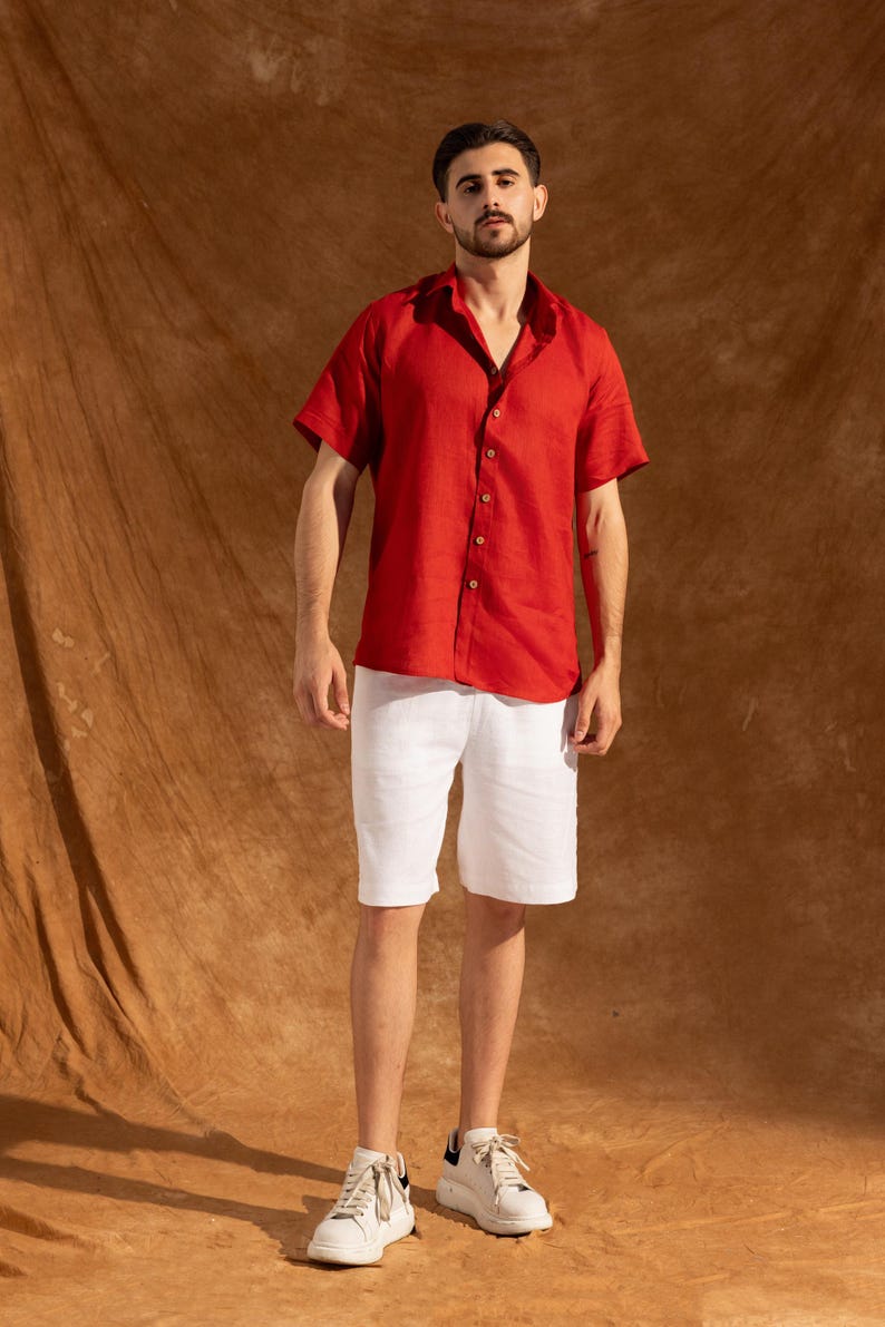 a man in a red shirt and white shorts