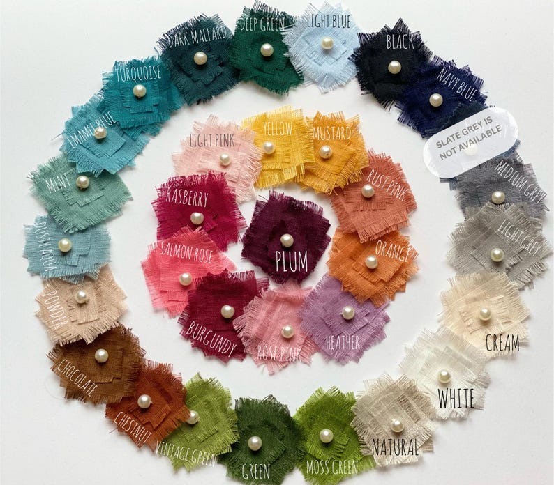 The image is a color wheel with various fabric swatches arranged in a circular pattern. The swatches are labeled with different colors and textures, such as turquoise, light blue, black, and white. The color wheel is a visual representation of the relationships between different colors and their relationships in terms of hue, value, and intensity.