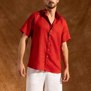 a man in a red shirt and white shorts