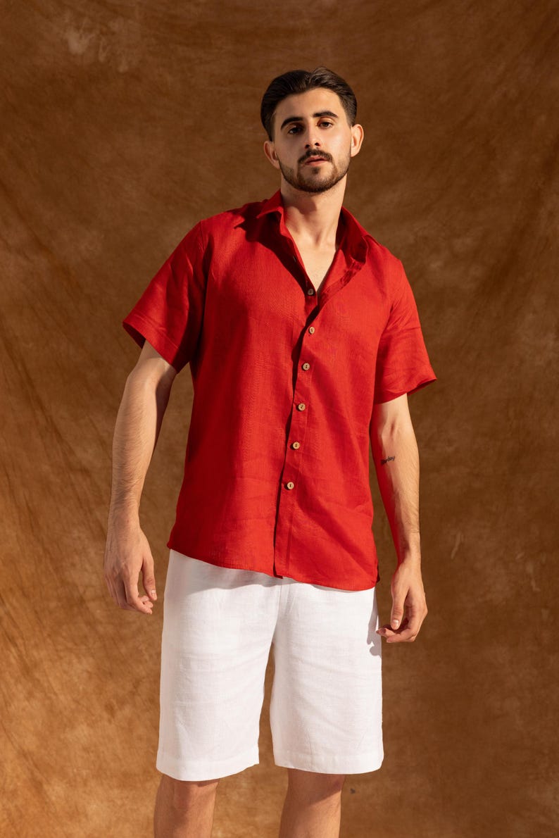a man in a red shirt and white shorts