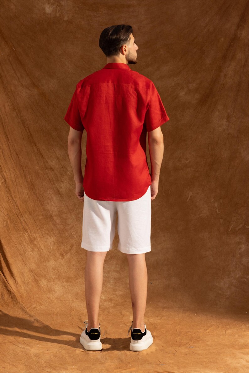 a man in a red shirt and white shorts