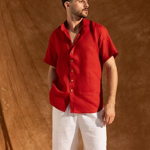 a man in a red shirt and white shorts