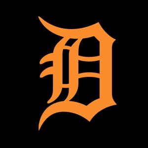 May include: An orange, stylized letter "D" against a black background. The "D" is in a classic, old English font, with ornate curves and serifs. The design is simple yet bold.
