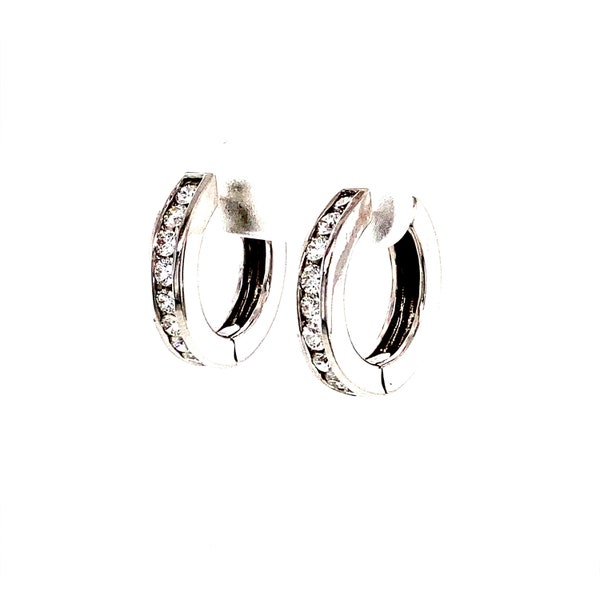 A sophisticated round earring crafted from 14K white gold and adorned with diamonds