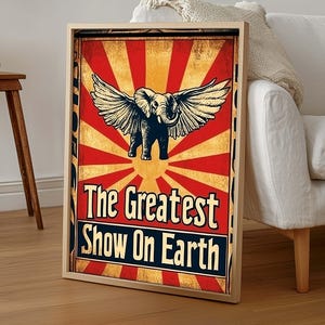 May include: A vintage-style poster with a red, white, and yellow color scheme. It features an elephant with wings and the text "The Greatest Show On Earth".