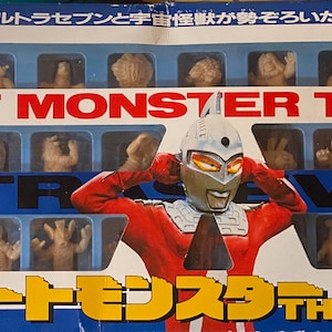 May include: A blue and white box with a picture of Ultraman and a collection of 30 small plastic figures of monsters. The box says "Great Monster The 30" and "Ultraseven" in large letters. The box is a toy from the 1990s.