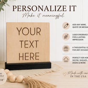 May include: A square light wood sign with the laser-engraved text YOUR TEXT HERE, set in a black rectangular base. The image includes text: PERSONALIZE IT, Make it meaningful, ADD ANY NAME, QUOTE OR MESSAGE, LASER ENGRAVED, A THOUGHTFUL GIFT, SIZES AVAILABLE 4" - 18".