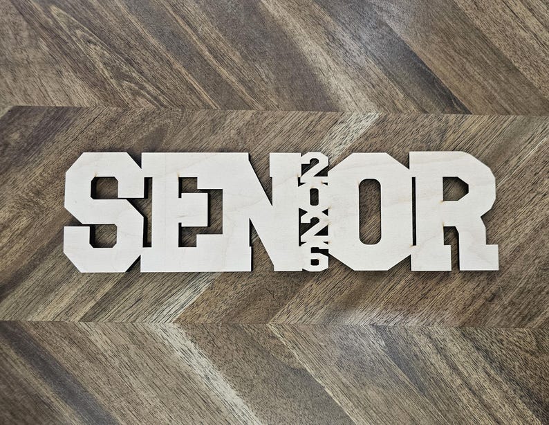 May include: Wooden sign with the word "SENIOR" and the year "2022" in white letters.