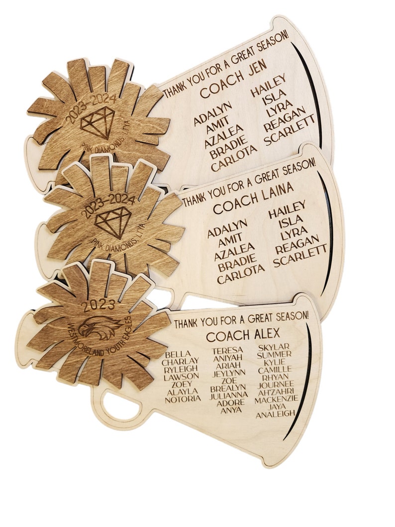 May include: Three wooden megaphones with the text "Thank you for a great season!" and the names of coaches and players. The megaphones are decorated with a diamond and an eagle.