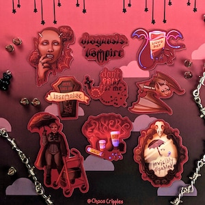 May include: A set of nine red and black stickers with various designs and text. The stickers feature a vampire, a bat, a coffin, a person with an umbrella, and a person with a walker. The text on the stickers includes "Diagnosiss Vampire", "Don't Pray for me", "Here Lies An Insomniac", "Liquid Diet", "Service Bat", "SPF 1000", and "Invisibly Disabled".