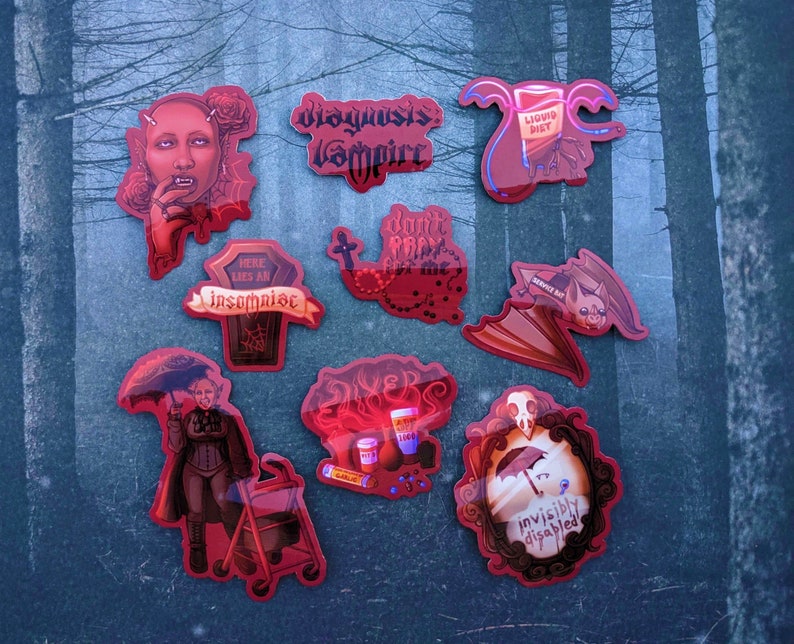 May include: A set of ten red and black stickers with various gothic and horror-themed illustrations and text. The stickers feature images of a vampire, a bat, a coffin, a blood bag, and a mirror. The text on the stickers includes "Disgusting Vampire", "Here Lies An Insomniac", "Don't Feed Me", "Liquid Diet", "Secret Bat", and "Invisible Disabled".