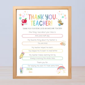 May include: A framed print with the words "THANK YOU, TEACHER!" in colorful letters. The print includes space for personalization and decorative elements like an apple, bee, and rainbow. The text expresses gratitude to a teacher.