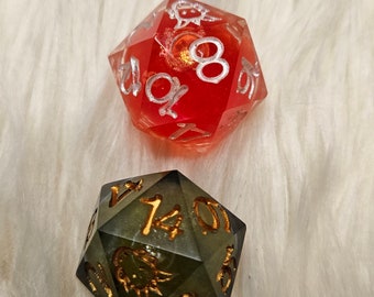 May include: Two dice, one red with white numbers and one green with gold numbers. The red die is a d8 and the green die is a d20.