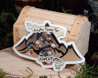 May include: A sticker featuring a mountain range design with the text "Are you ready for... Adventure!" The mountain range is filled with colourful dice.