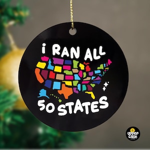 May include: A black round Christmas ornament with a colorful map of the United States and the text "I ran all 50 states".