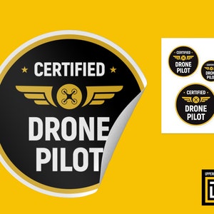 May include: A black and gold sticker with the text "*CERTIFIED* DRONE PILOT" and a drone icon. The sticker is peeling off of a white background.