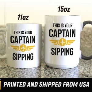 11oz and 15oz white mug next to each other with a graphic of an aviation wing and the text this is your captain sipping