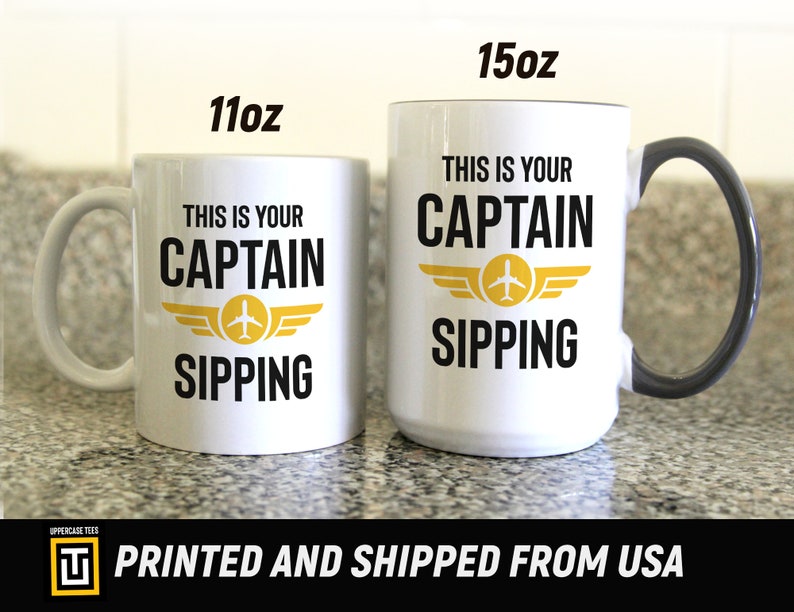 11oz and 15oz white mug next to each other with a graphic of an aviation wing and the text this is your captain sipping