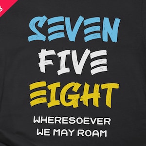 May include: Black t-shirt with yellow, blue and white text that reads "Seven Five Eight Wherever We May Roam".