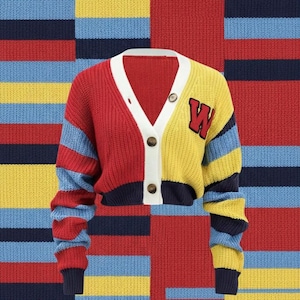 May include: A color-blocked cardigan sweater in red, yellow, and blue. The sweater has a white trim, button closure, and a red "W" patch on the yellow section. The background is a matching color-blocked pattern.