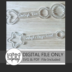 May include: Two clear acrylic bubble wands with decorative shapes and text. One wand has a heart shape and reads "Everleigh Rain." The other has a star shape and reads "Everleigh's Magic Wand." The image also includes the text "DIGITAL FILE ONLY" and "SVG & PDF File Included."