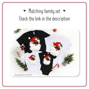 May include: Matching family Christmas shirts featuring a black Santa Claus with a white beard and red hat. The shirts are available in black and white.