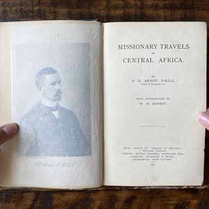 May include: A vintage book titled "Missionary Travels in Central Africa" by F.S. Arnot, F.R.G.S. with an introduction by W.H. Bennet. The book cover features a black and white portrait of the author.