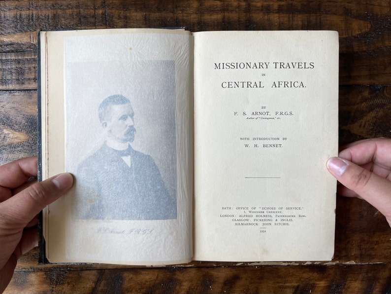 May include: A vintage book titled "Missionary Travels in Central Africa" by F.S. Arnot, F.R.G.S. with an introduction by W.H. Bennet. The book cover features a black and white portrait of the author.