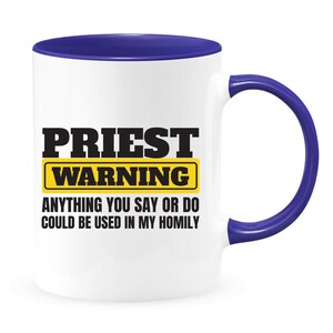 May include: White ceramic coffee mug with a blue rim and handle. The mug has a black and yellow graphic that says "Priest Warning" and "Anything you say or do could be used in my homily."