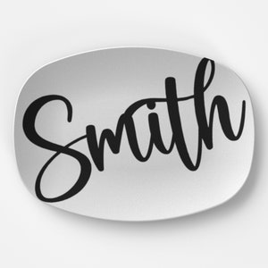 May include: White oval serving platter with the word "Smith" written in black cursive script.