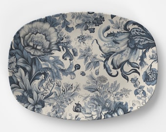 May include: An oval serving platter with a blue and white floral pattern. The pattern features stylized flowers and leaves in a repeating design.