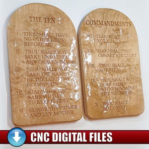 May include: Two wooden plaques with the Ten Commandments engraved. The plaques are light brown with a glossy finish. The text is etched into the wood. The words "THE TEN" and "COMMANDMENTS" are at the top of each plaque. The bottom of the image has the text "CNC DIGITAL FILES".