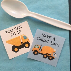 May include: Two motivational cards with construction vehicle illustrations. The first card says "You can do it!" and features a yellow dump truck. The second card says "Have a great day!" and features a yellow cement mixer.