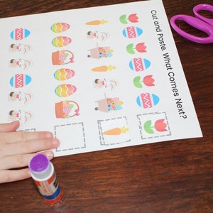 May include: A printable Easter activity sheet with a cut and paste game. The sheet has images of Easter eggs, bunnies, carrots, and tulips. The instructions read "Cut and Paste. What Comes Next?"