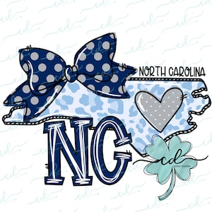 May include: A blue and white polka dot bow sits on top of a blue and white patterned outline of the state of North Carolina. The state abbreviation "NG" is written in large blue letters. A small blue heart with white polka dots is inside the state outline. A green four-leaf clover is in the bottom right corner.