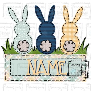 May include: Three bunny-shaped fabric appliques with a patchwork design. The bunnies are blue, yellow, and green. The bunnies are sitting on a bed of green grass. The text "NAME" is written in a yellow font on a blue and white plaid background. The text "sewing seeds + clover doodle" is written in a black font on a white background.