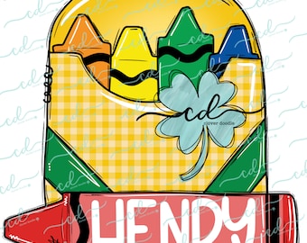 May include: A yellow and green crayon box with a four-leaf clover and the name "HENRY" written on a red crayon.